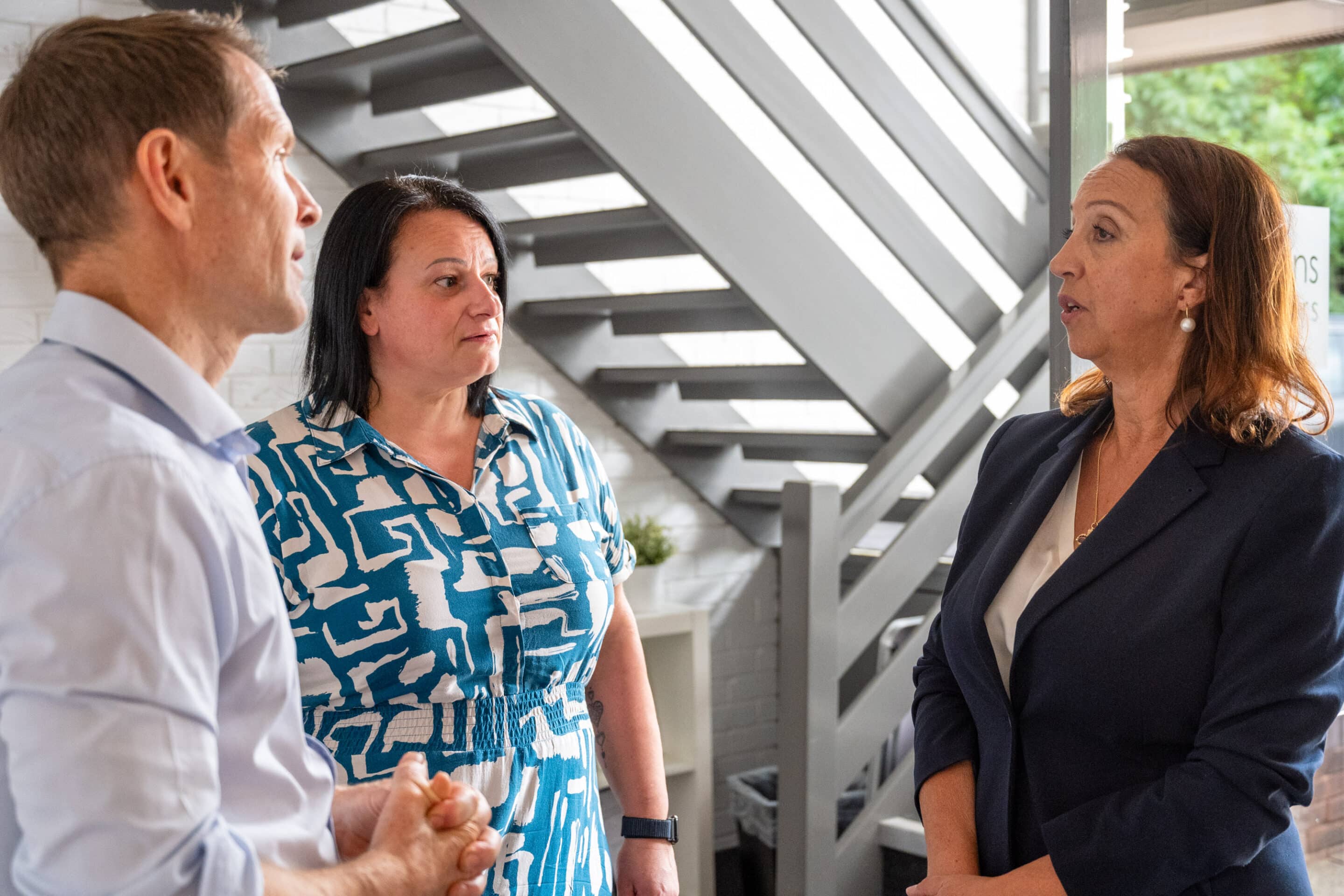 Three people talking in the Payton Solicitors reception